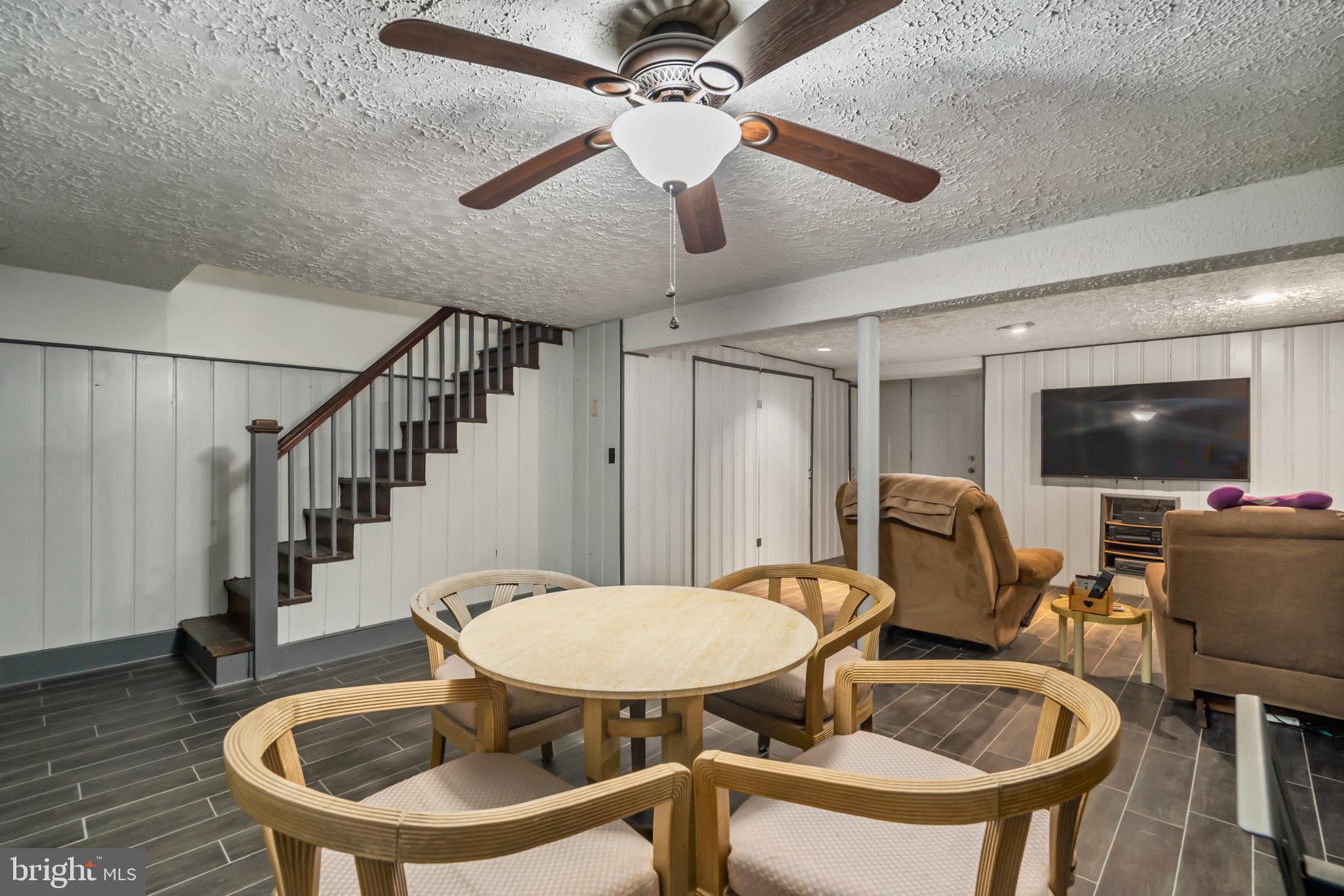 3704 Monterey Road Baltimore, MD 21218 - Photo 24 of 32 a view of a livingroom with furniture a flat screen tv and a ceiling fan