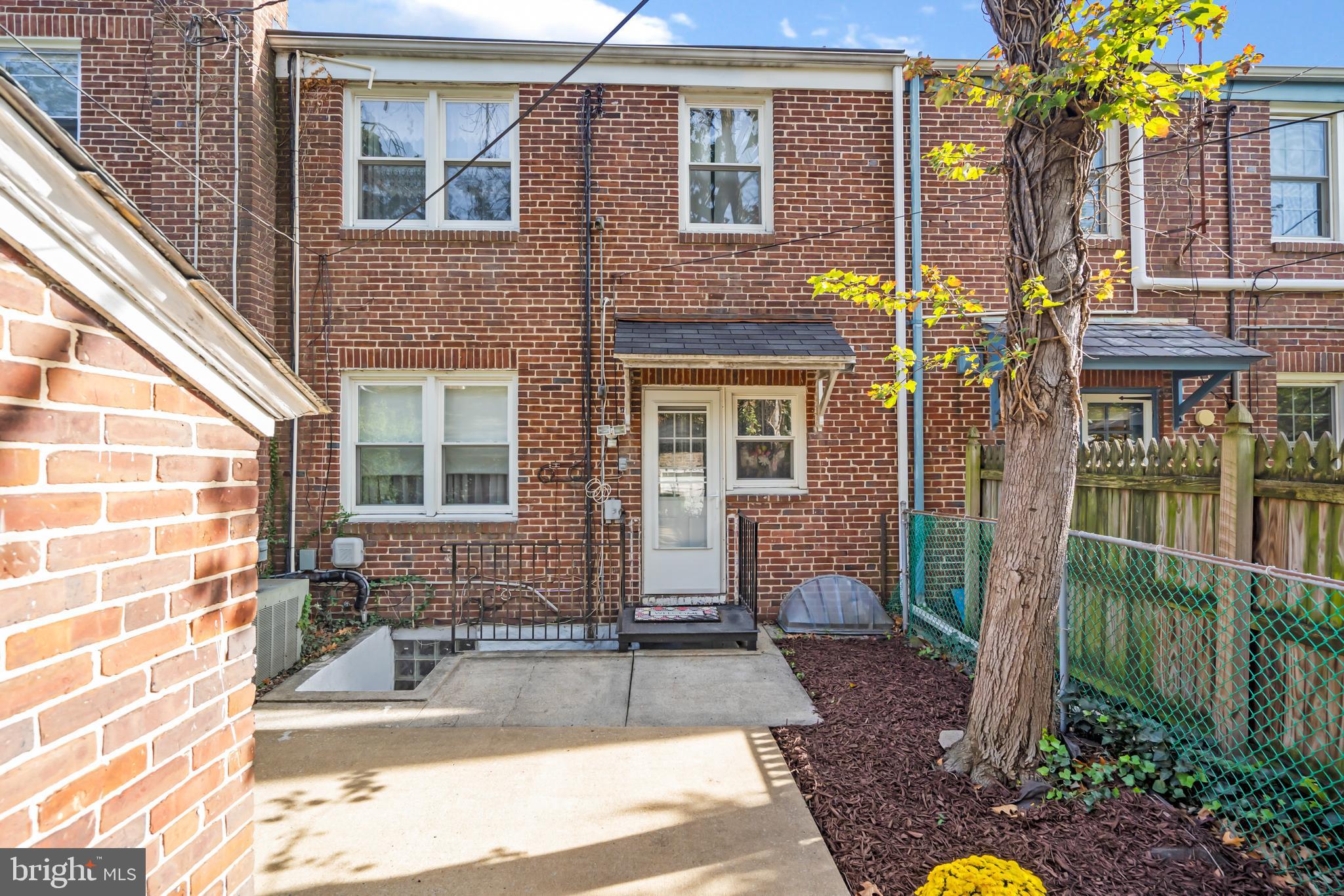 3704 Monterey Road Baltimore, MD 21218 - Photo 29 of 32 a view of a brick house with large windows and plants