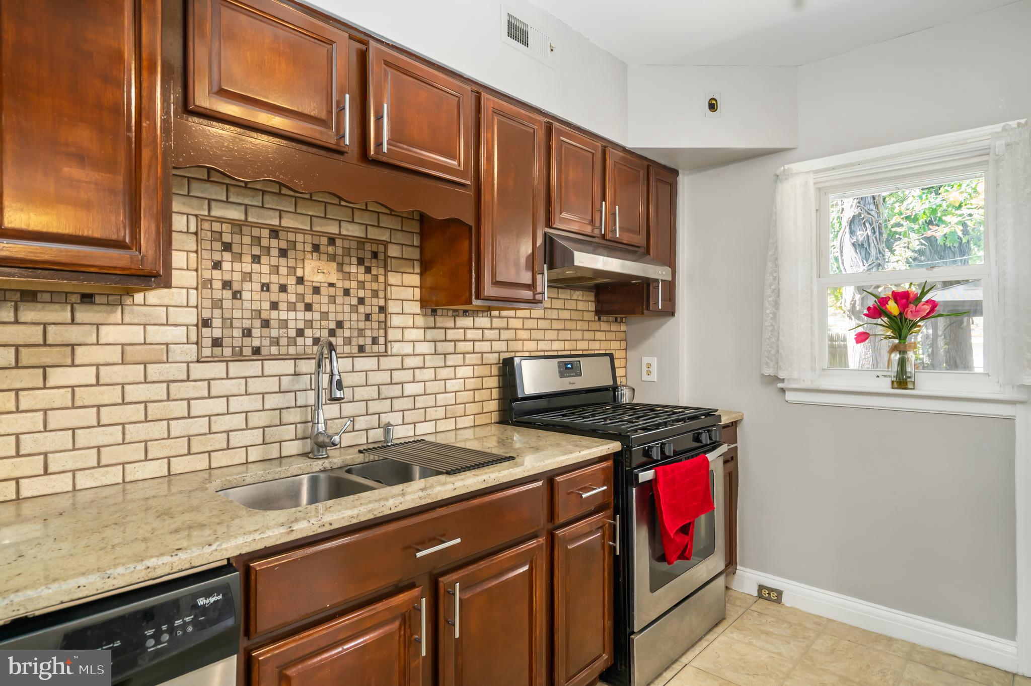 3704 Monterey Road Baltimore, MD 21218 - Photo 10 of 32 a kitchen with stainless steel appliances granite countertop a sink stove and cabinets