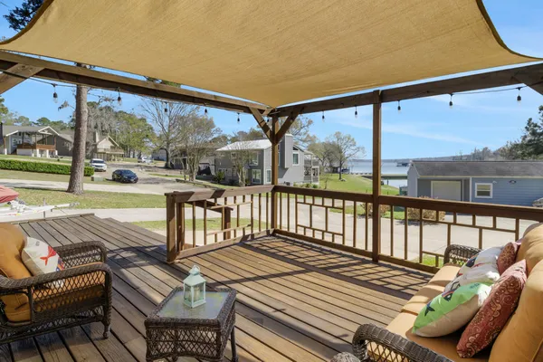 a view of a patio with a table chairs and wooden floor