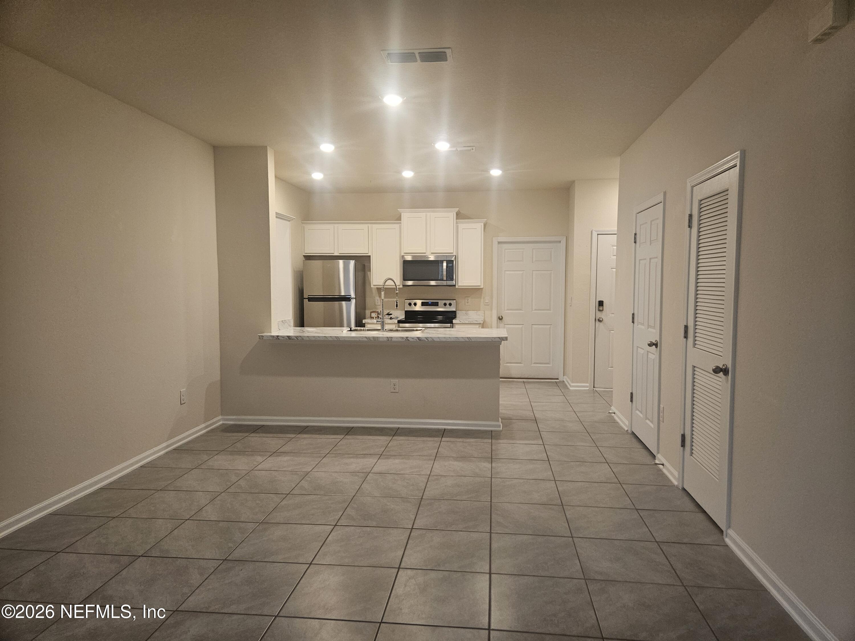 86640 Shortline Circle Yulee, FL 32097 - Photo 7 of 11 a kitchen with granite countertop a sink and cabinets