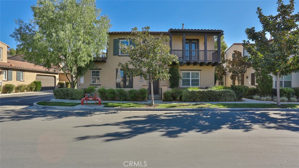 a view of road with house and trees in the background
