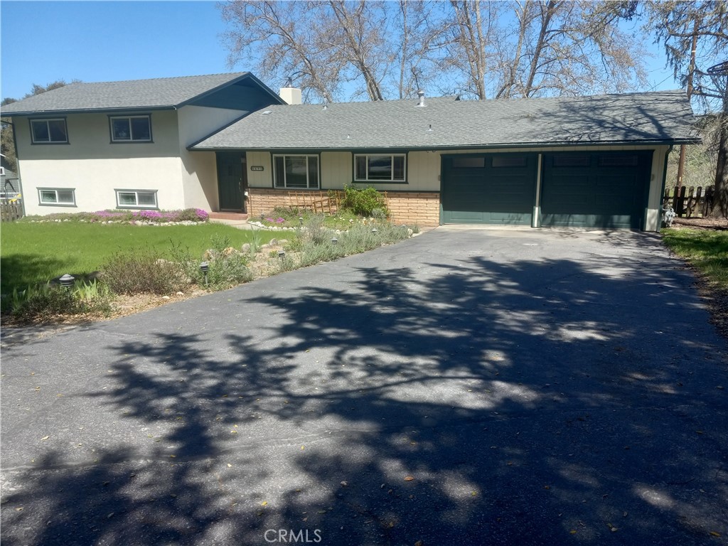 6601 Portola Road Atascadero, CA 93422 - Photo 1 of 1 a front view of a house with a yard and garage