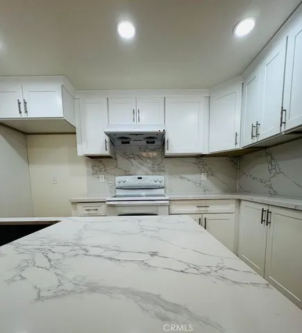 a kitchen with stainless steel appliances granite countertop a sink and cabinets