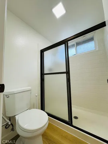 a bathroom with a toilet and a shower