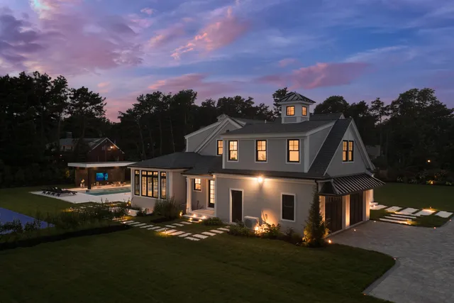 a bedroom with a bed table and a window