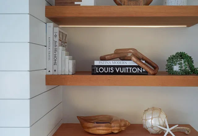 a view of a hallway with wooden floor and windows