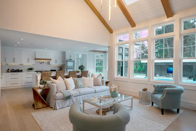 a bedroom with a bed and a dresser next to a window