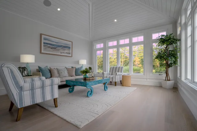 an empty room with wooden floor and white cabinet