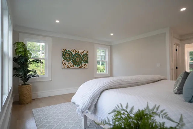 a living room with furniture pool table and kitchen view