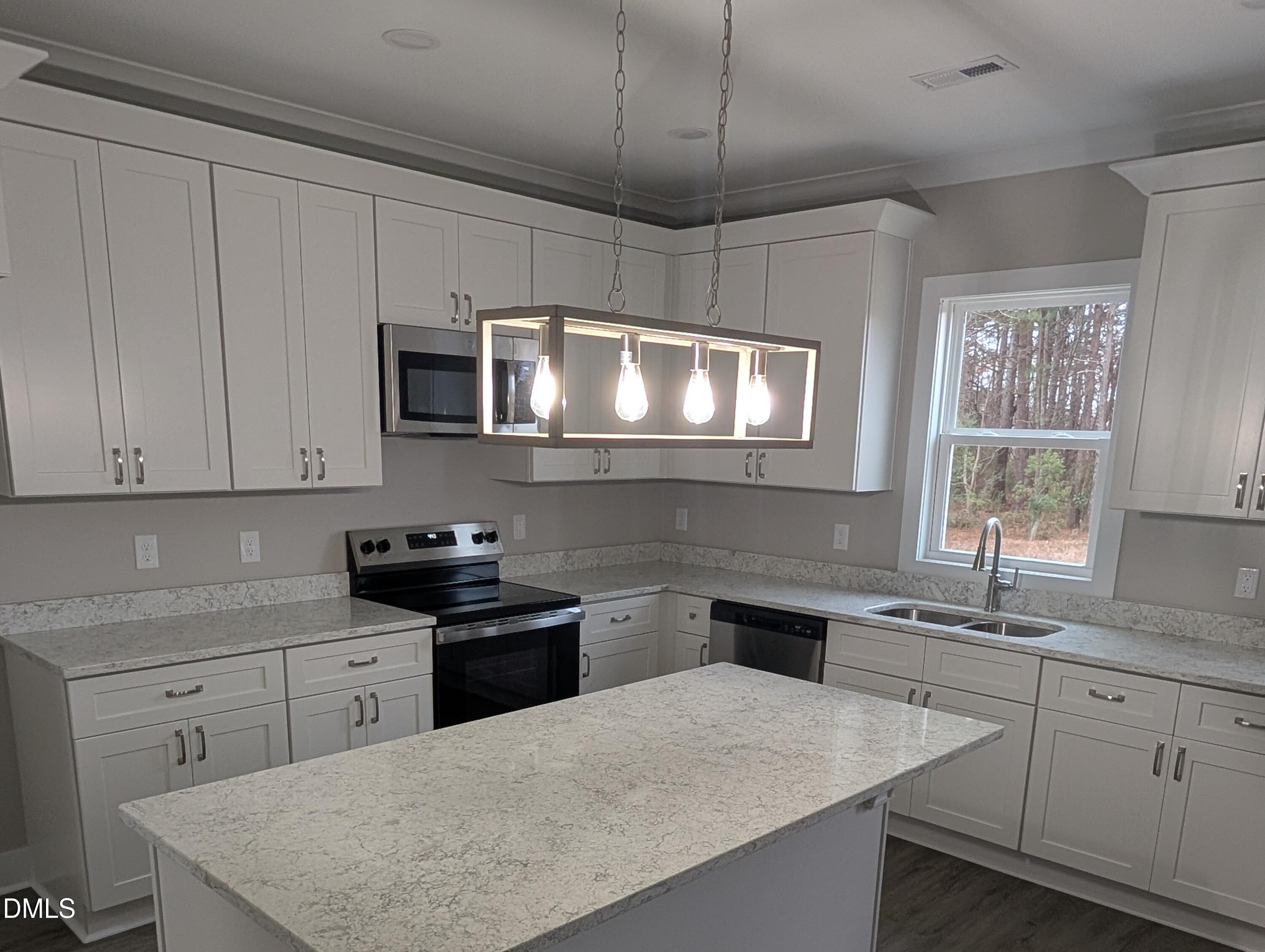 749 West Church Street Angier, NC 27501 - Photo 12 of 37 a kitchen with stainless steel appliances a sink stove and microwave