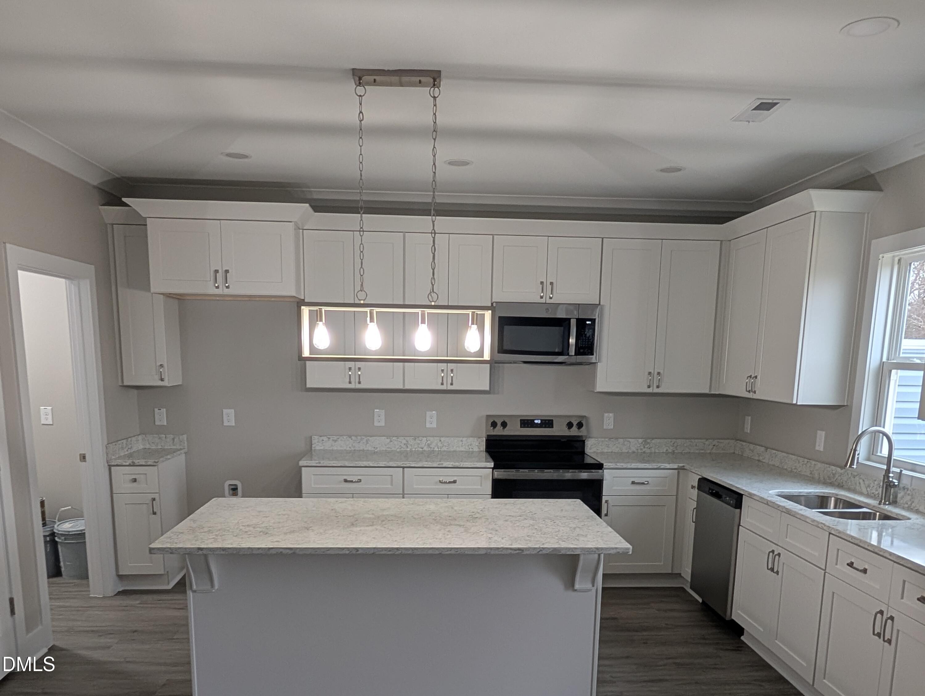 749 West Church Street Angier, NC 27501 - Photo 13 of 37 a kitchen with stainless steel appliances kitchen island granite countertop a sink a stove and cabinets