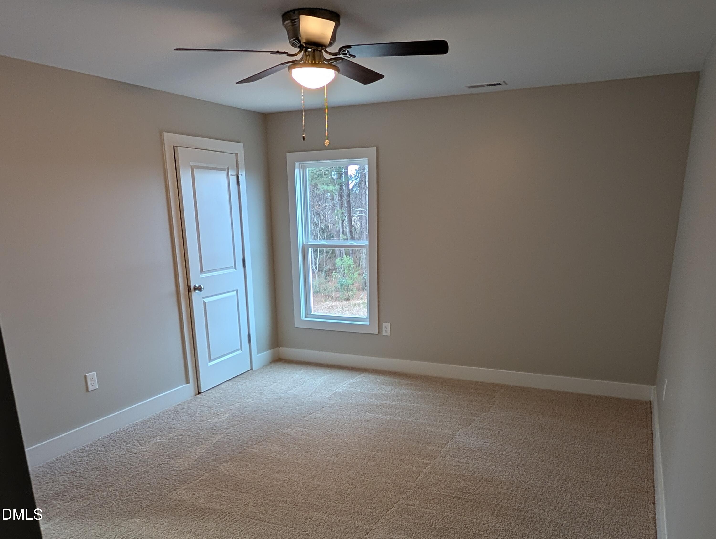 749 West Church Street Angier, NC 27501 - Photo 21 of 37 an empty room with windows and fan