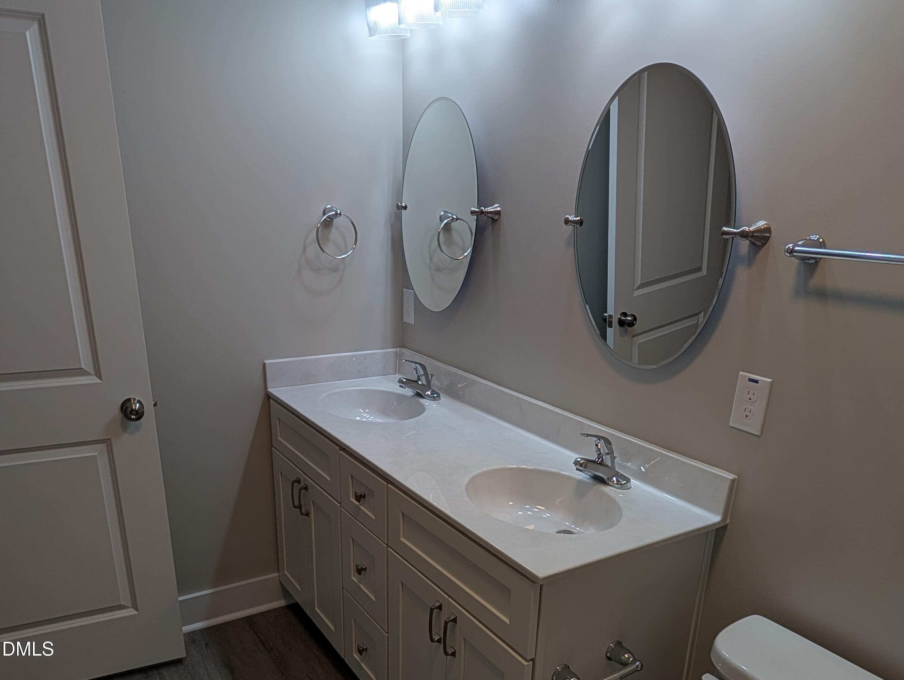 749 West Church Street Angier, NC 27501 - Photo 22 of 37 a bathroom with a double vanity sink and mirror