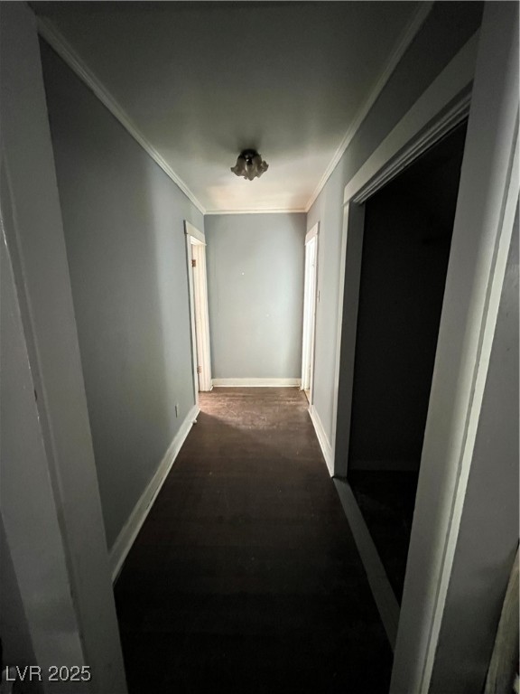 623 Murry Street Ely, NV 89301 - Photo 3 of 6 Hallway with crown molding and dark wood-type flooring