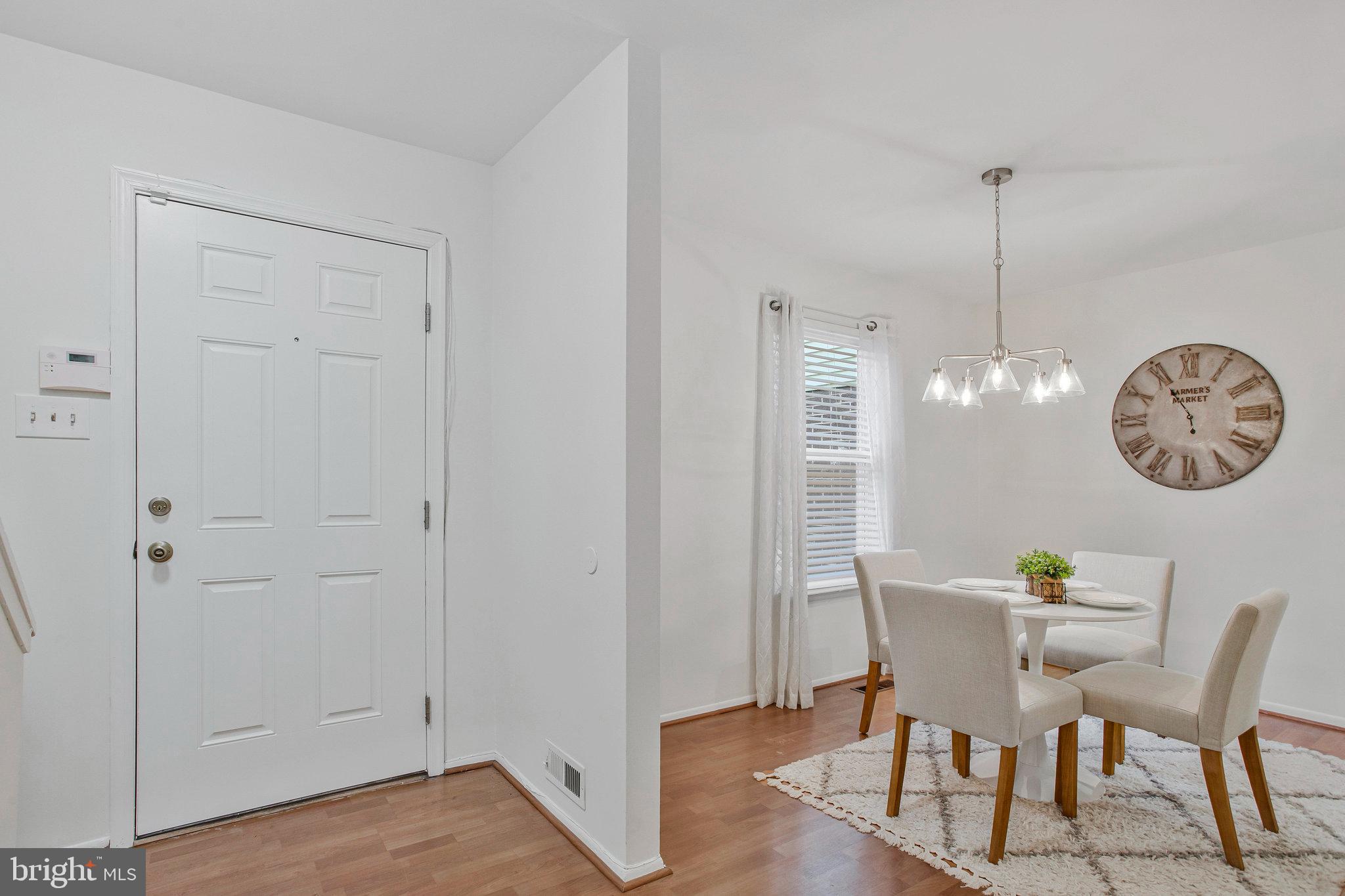 1805 Graybird Court Severn, MD 21144 - Photo 11 of 35 a view of a dining room with furniture a chandelier and wooden floor