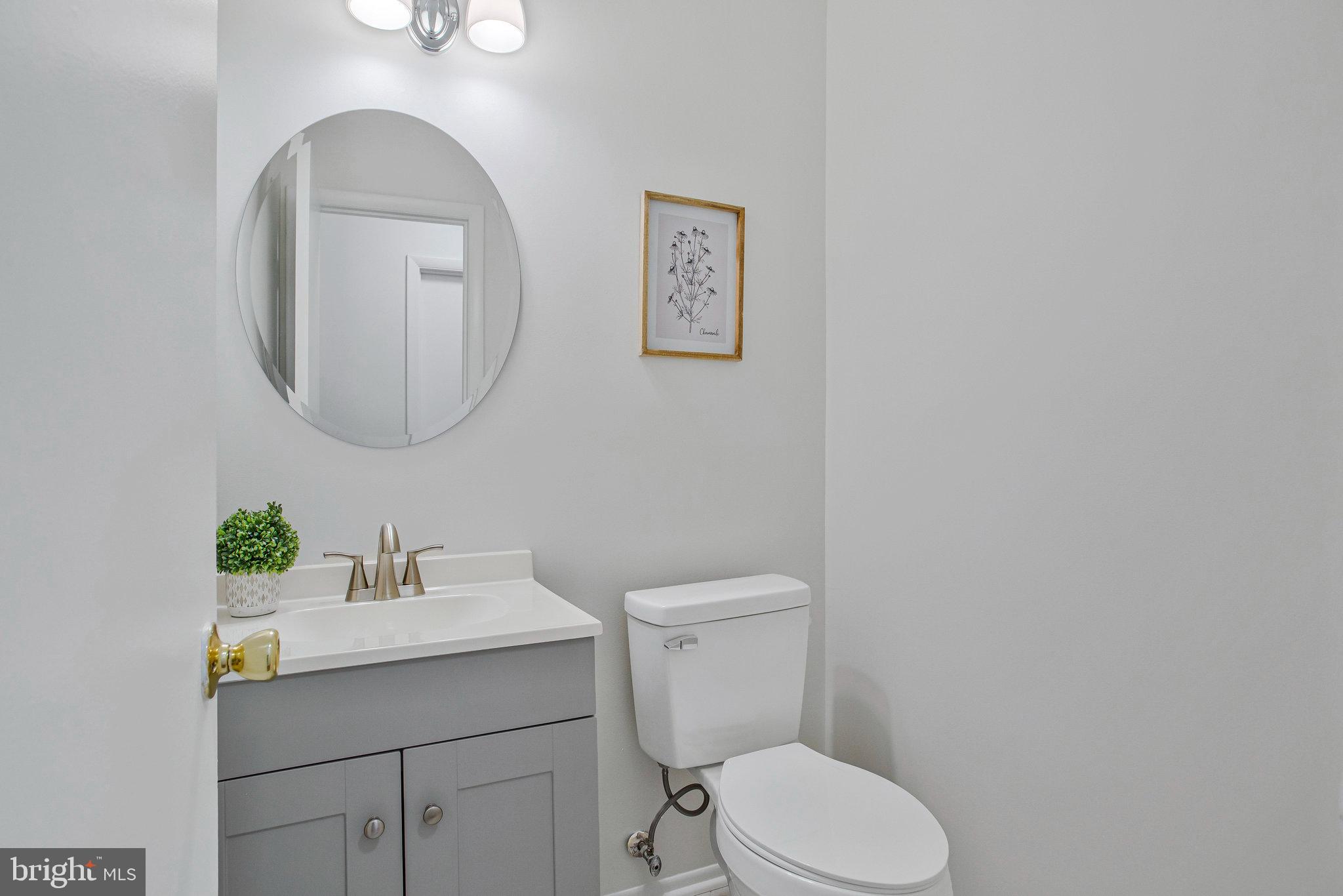 1805 Graybird Court Severn, MD 21144 - Photo 12 of 35 a bathroom with a toilet a sink and mirror