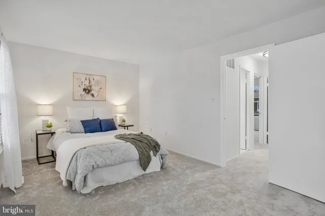 a bed room with a bed and a night stand