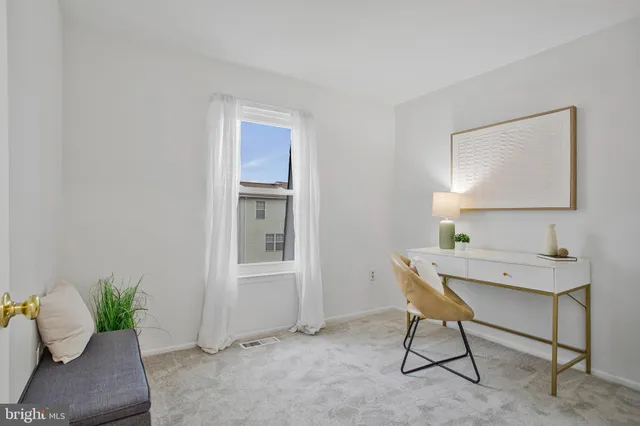 a living room with furniture and a ceiling fan