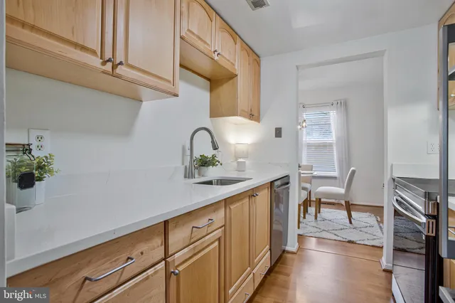 a hallway with sink and cabinets
