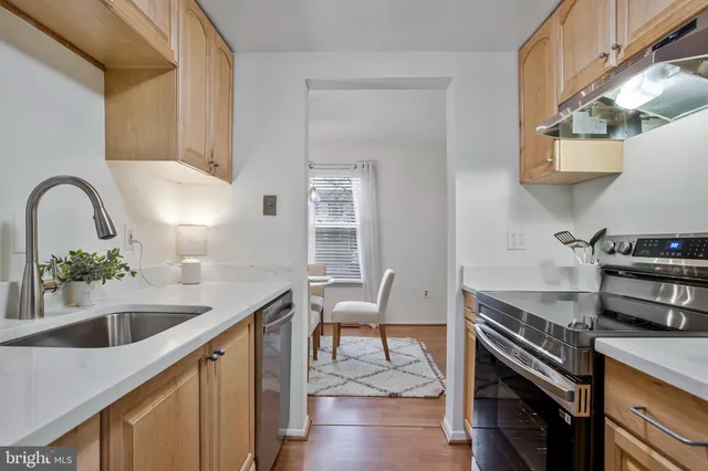 a kitchen with a sink cabinets and window