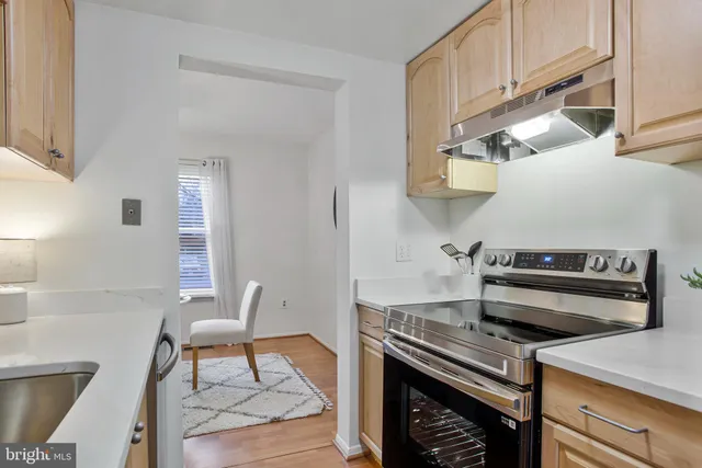 a stove top oven sitting inside of a kitchen