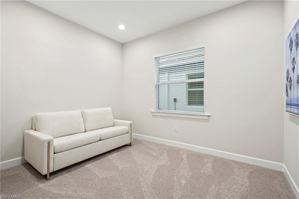 8795 Calypso Court Naples, FL 34113 - Photo 19 of 49 a living room with furniture and a window