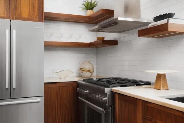 a kitchen with stainless steel appliances granite countertop a sink stove and cabinets