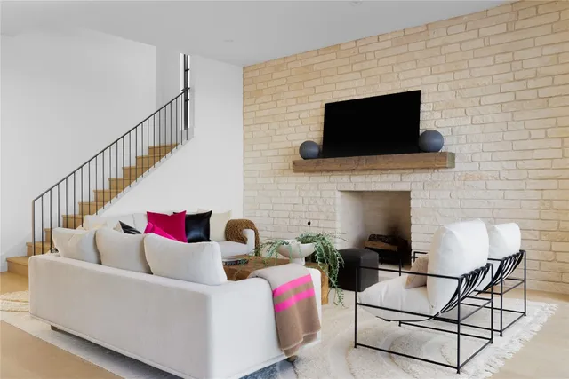 a living room with furniture and paintings on the wall
