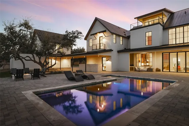 a view of a house with swimming pool and sitting area