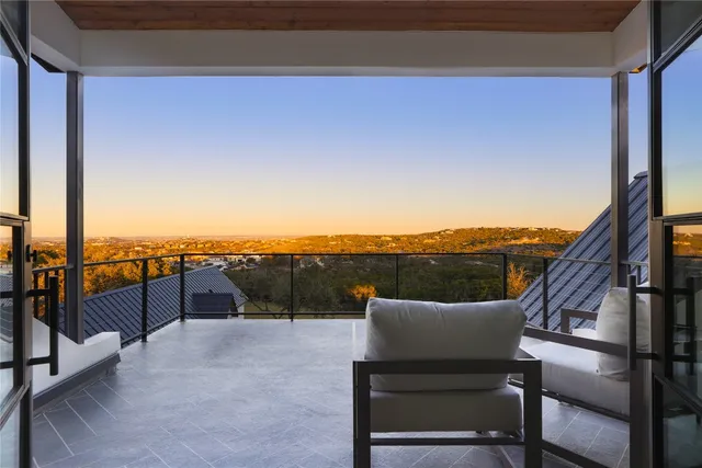 a view of a white house with a yard