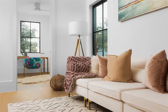 a living room with a bed furniture and a window
