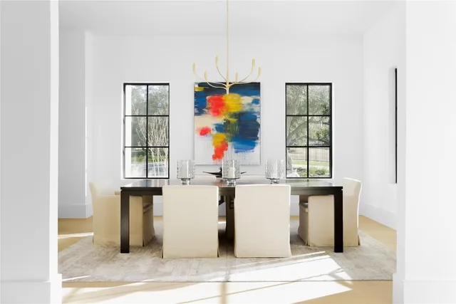 a view of a kitchen with stainless steel appliances wooden floor and window