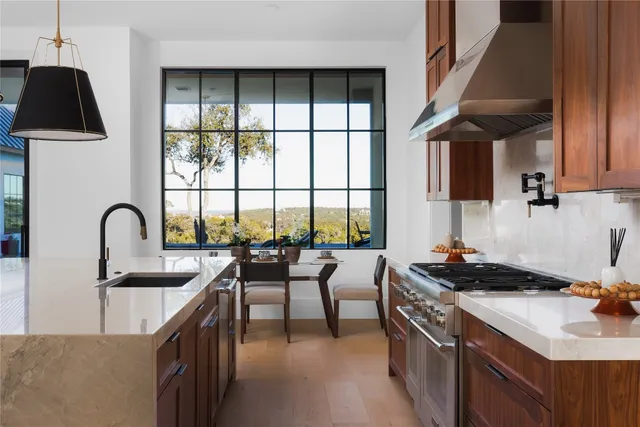 a kitchen with a sink a stove and cabinets