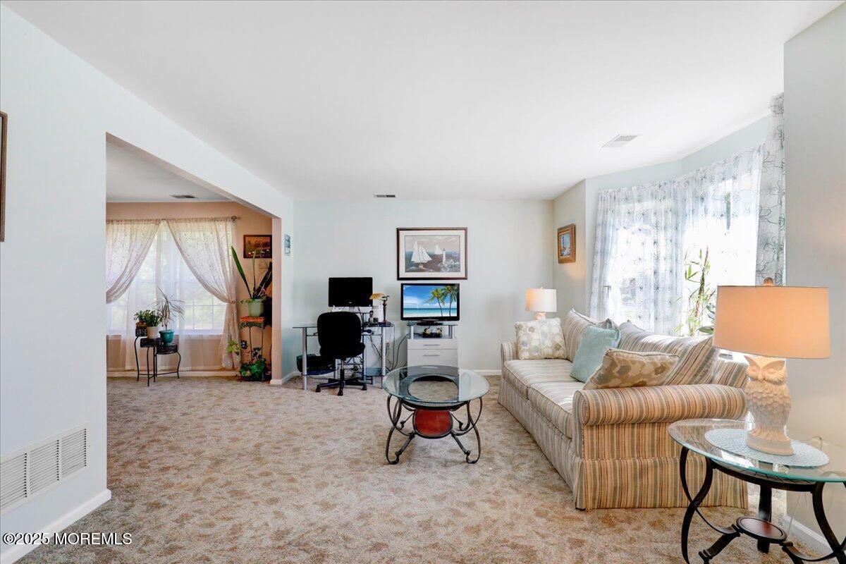 664 Adelphia Road Freehold, NJ 07728 - Photo 14 of 35 a living room with furniture a large window and a flat screen tv