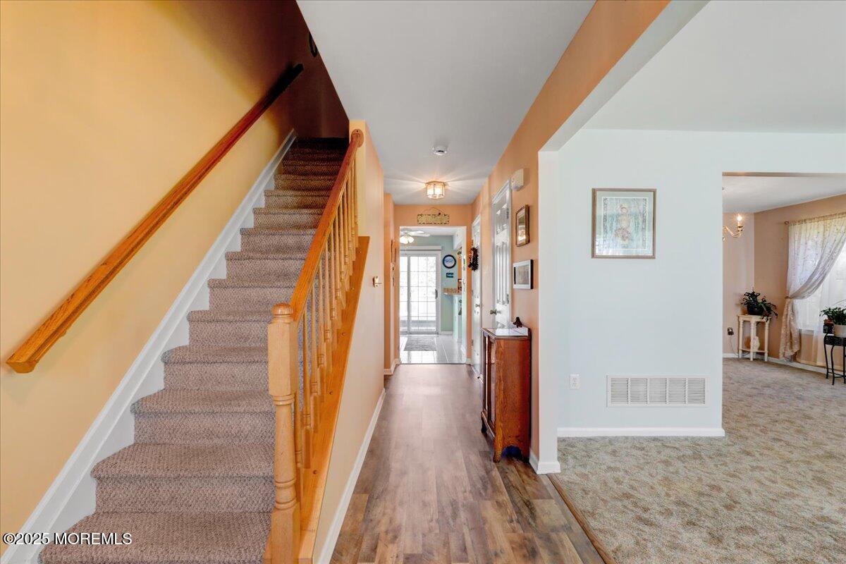 664 Adelphia Road Freehold, NJ 07728 - Photo 17 of 35 a view of a hallway with wooden floor and staircase