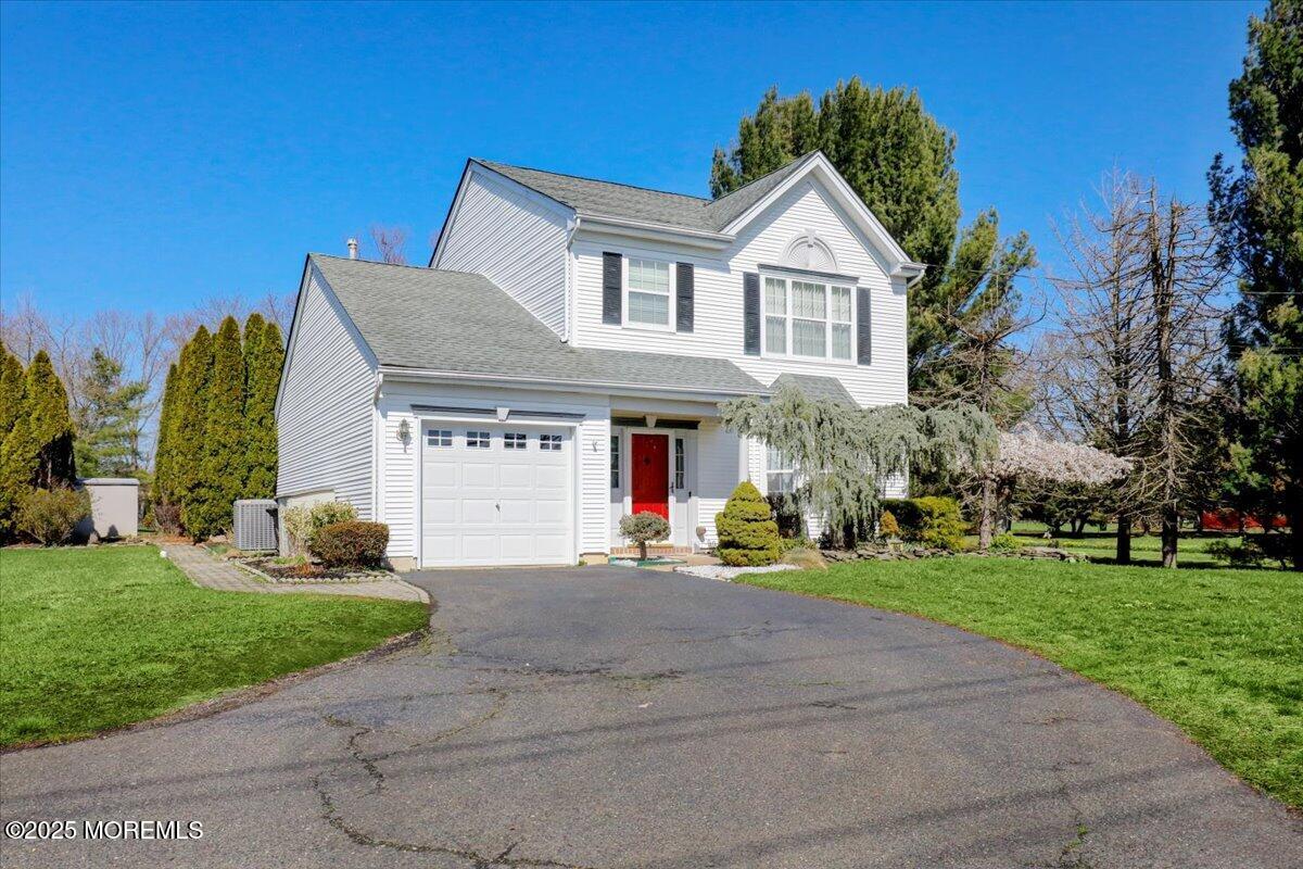 664 Adelphia Road Freehold, NJ 07728 - Photo 2 of 35 a front view of a house with a yard and potted plants