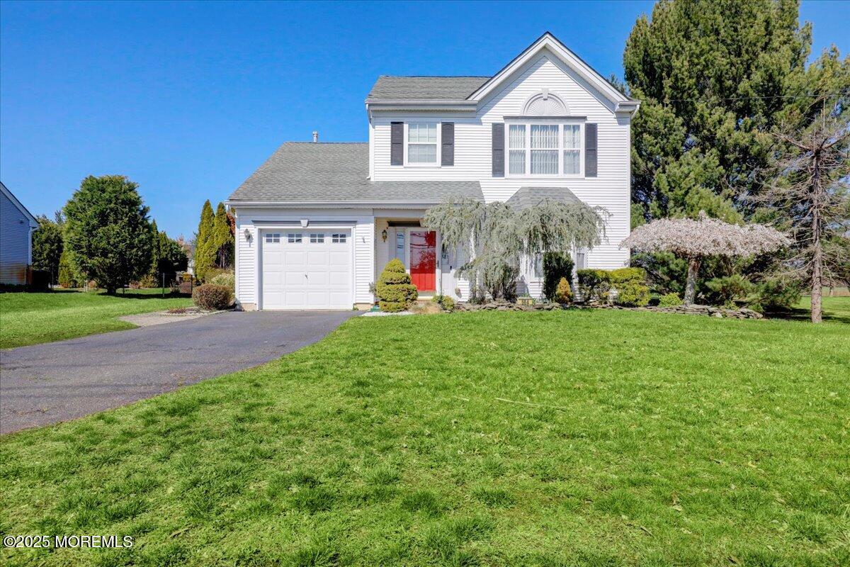 664 Adelphia Road Freehold, NJ 07728 - Photo 3 of 35 a front view of a house with a yard and garage