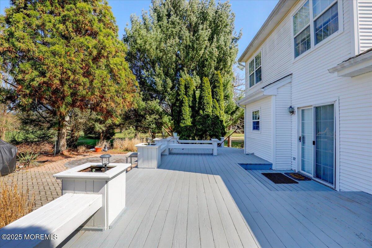 664 Adelphia Road Freehold, NJ 07728 - Photo 31 of 35 a view of a patio with couches and table and chairs with wooden floor and fence