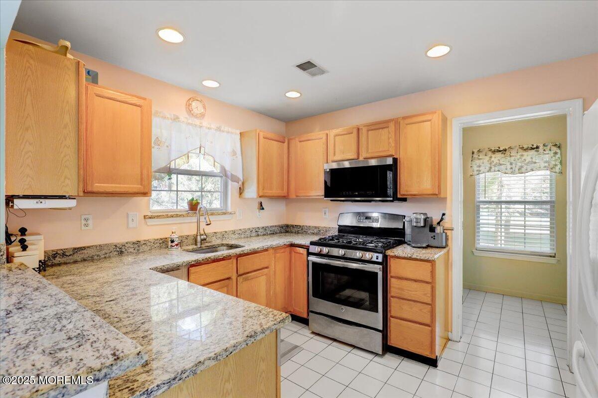 664 Adelphia Road Freehold, NJ 07728 - Photo 4 of 35 a kitchen with stainless steel appliances granite countertop a stove sink and microwave