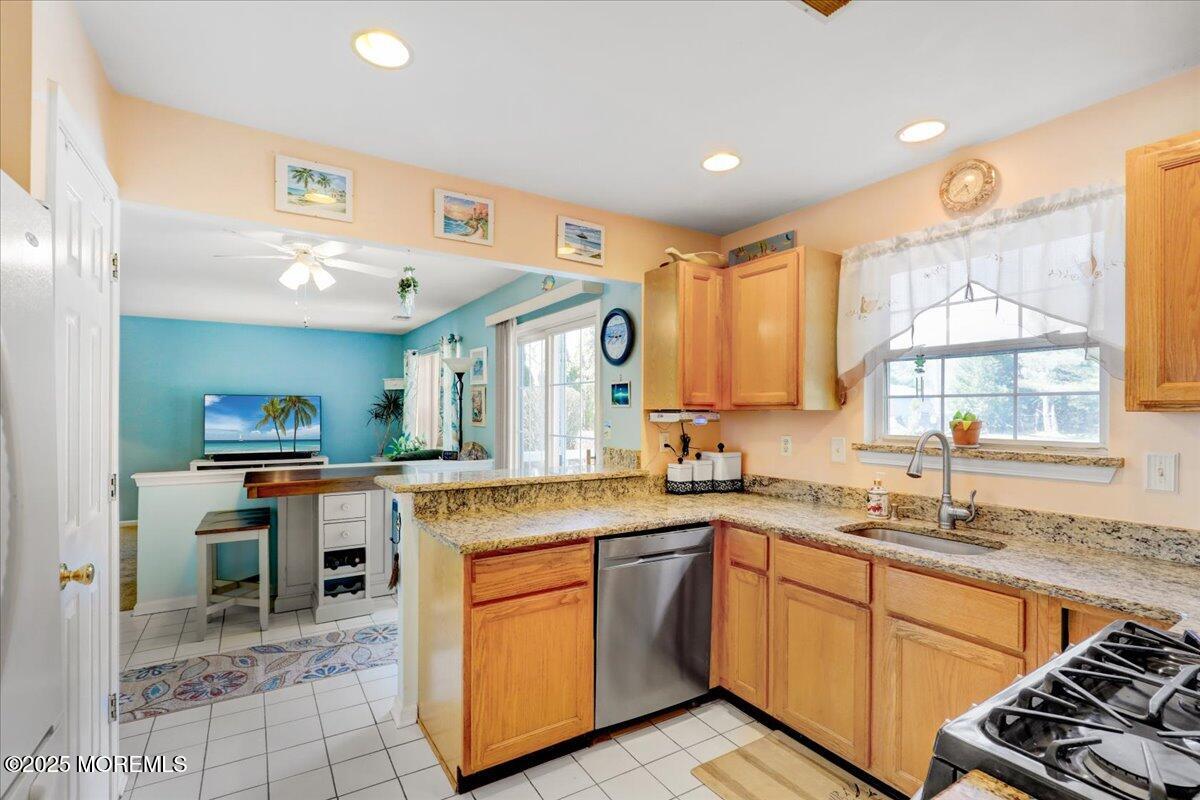 664 Adelphia Road Freehold, NJ 07728 - Photo 5 of 35 a kitchen with stainless steel appliances granite countertop a sink and cabinets