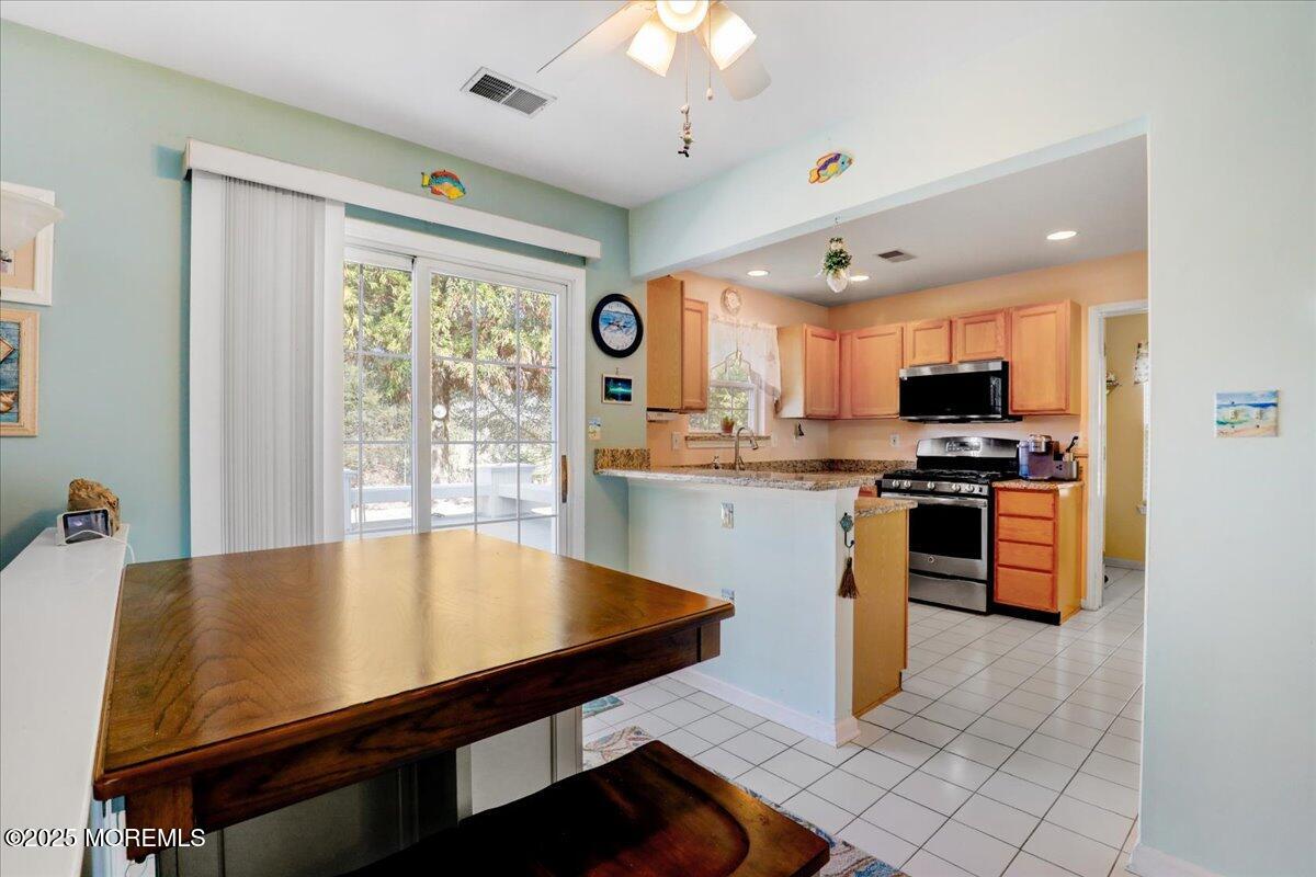 664 Adelphia Road Freehold, NJ 07728 - Photo 8 of 35 a kitchen with stainless steel appliances granite countertop a stove a sink dishwasher and a refrigerator with wooden floor