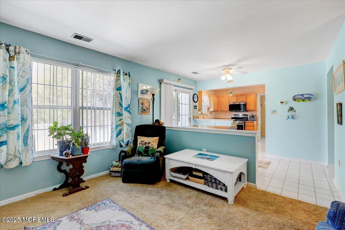 664 Adelphia Road Freehold, NJ 07728 - Photo 9 of 35 a living room with furniture gym equipment and a large window