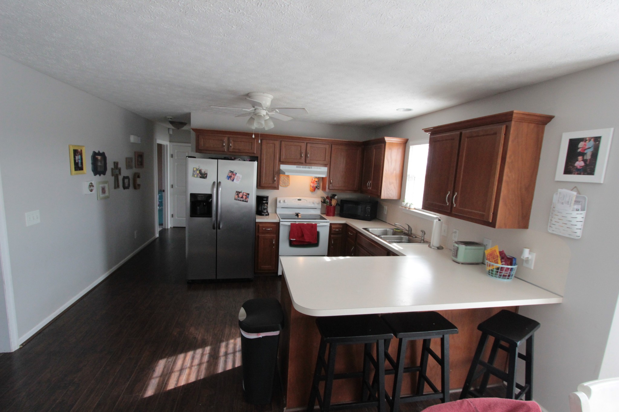 628 Roberts Road Watertown, TN 37184 - Photo 4 of 11 a kitchen with stainless steel appliances a table chairs sink refrigerator and cabinets