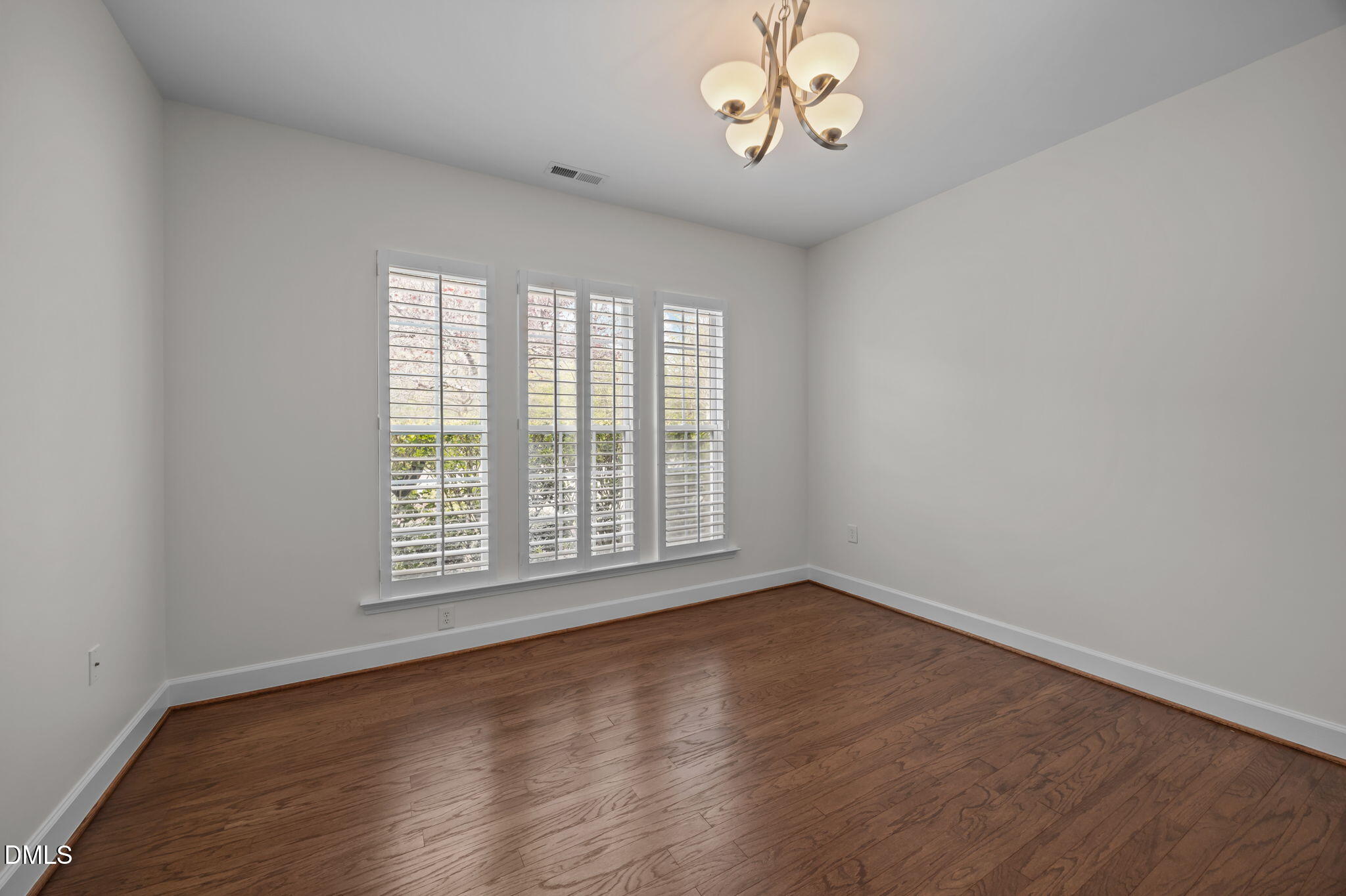 268 Beckingham Loop Cary, NC 27519 - Photo 14 of 36 an empty room with wooden floor and windows