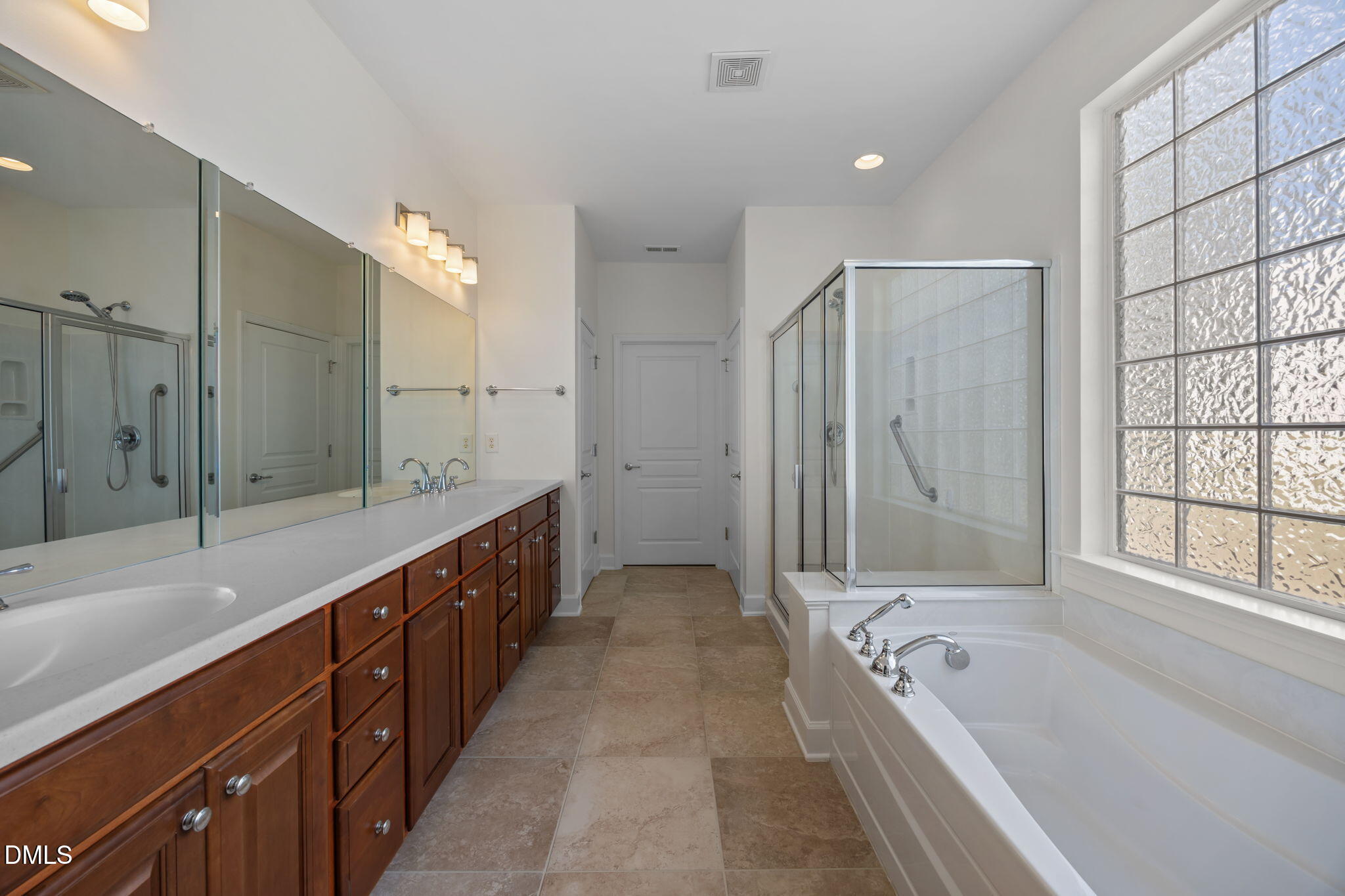 268 Beckingham Loop Cary, NC 27519 - Photo 22 of 36 a bathroom with a tub a double vanity sink and large mirror