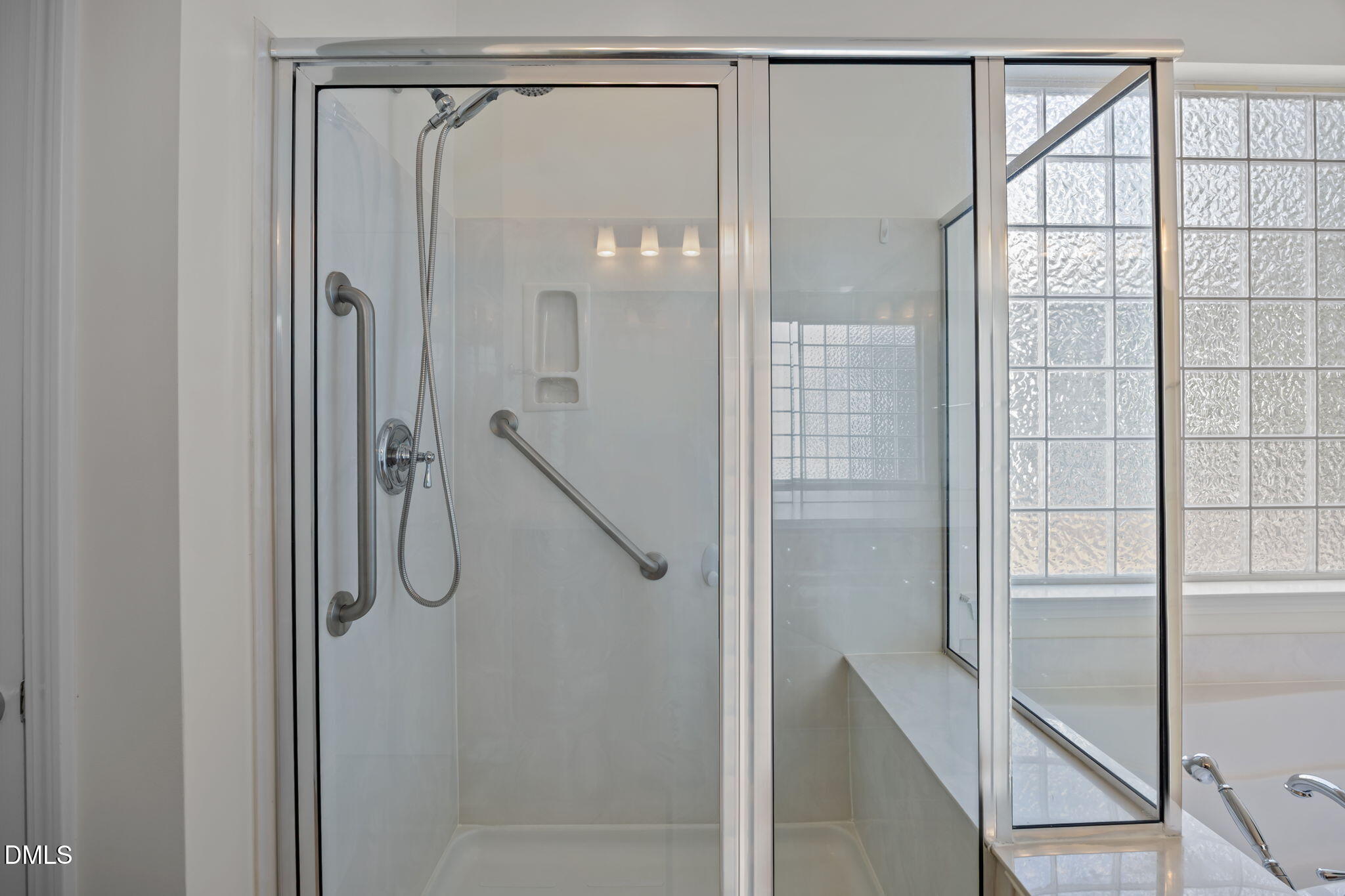 268 Beckingham Loop Cary, NC 27519 - Photo 24 of 36 a bathroom with a glass shower door