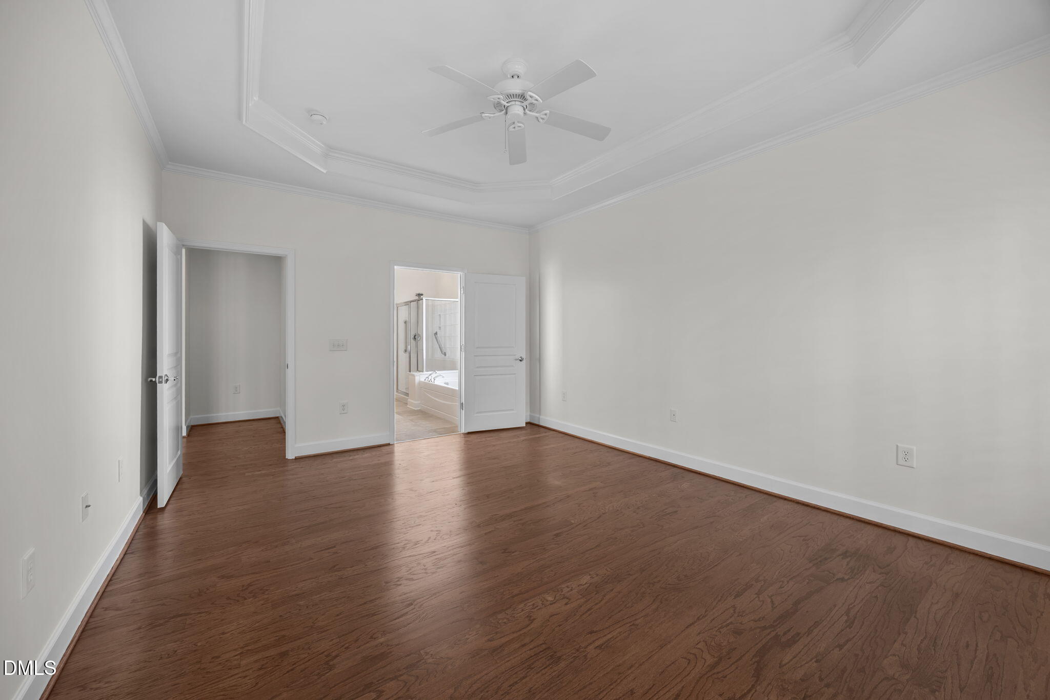 268 Beckingham Loop Cary, NC 27519 - Photo 25 of 36 a view of an empty room with wooden floor and a ceiling fan