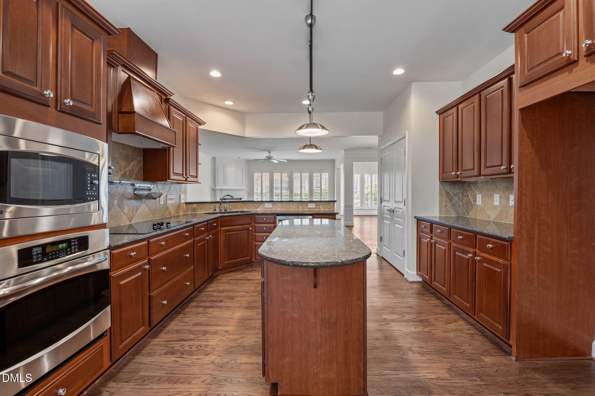 268 Beckingham Loop Cary, NC 27519 - Photo 8 of 36 a large kitchen with stainless steel appliances wooden cabinets a stove and a sink