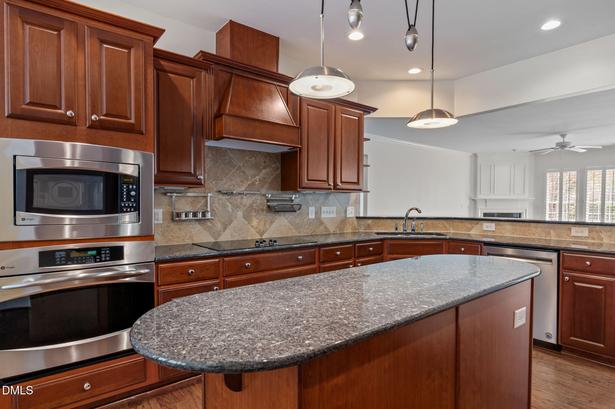 268 Beckingham Loop Cary, NC 27519 - Photo 9 of 36 a kitchen with stainless steel appliances granite countertop a sink a stove and a microwave